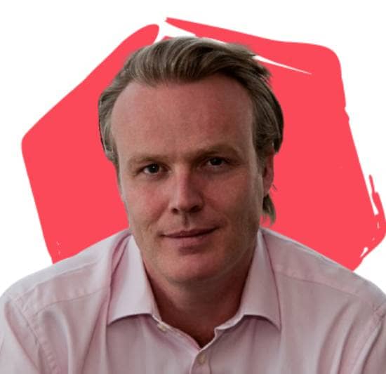 Paul Britton, Board Director, in front of a red hexagon